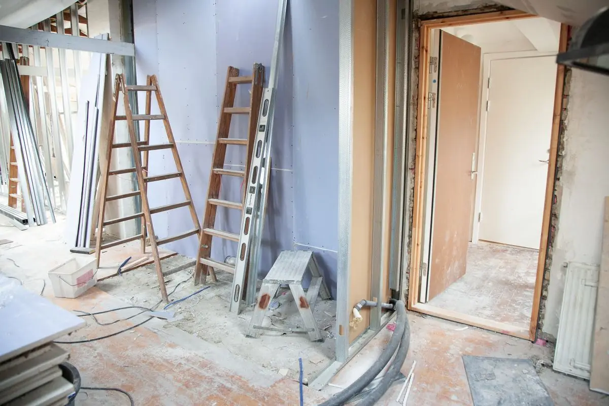 A room with open walls and exposed framing during a renovation